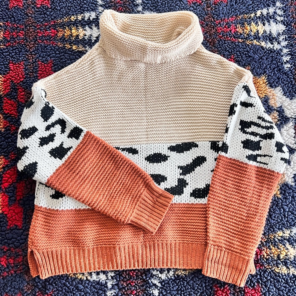 Woman’s cowl neck cheetah print sweater.